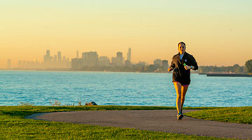 Girl running by the lake front